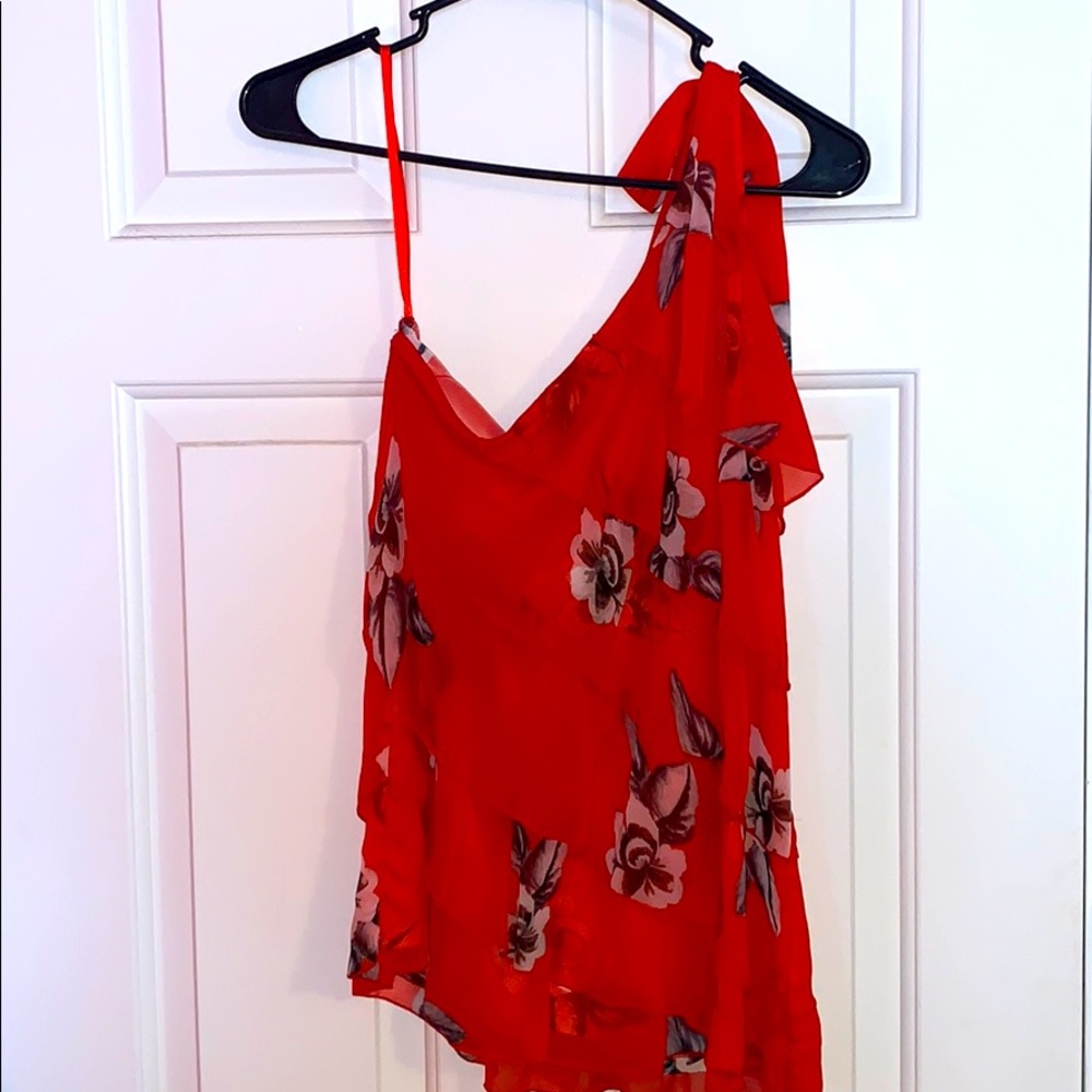 One sleeved red, ruffled shirt